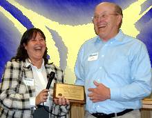 CEO, Elaine Miller presents Charlie Ortiez with special award