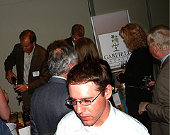 Guests Gather 'round the wine-tasting table.