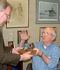 Admiral Truly shows Larry Nelson one of the bolts holding spacecraft in place before takeoff. At take off, this bolt is cut in half. The bolt shown here was from one of Admiral Truly's missicons.